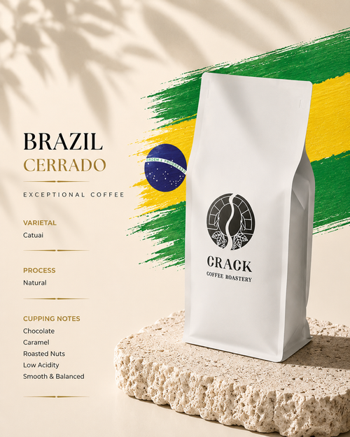 A white bag of CRACK COFFEE BLAERY Brazil Cerrado coffee stands on a textured stone slab against a warm beige background with a green and yellow brushstroke graphic and text describing the coffee varietal, process, and cupping notes.