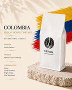 A white bag of Crack Coffee Roastery Colombia Huila Coconut Infused coffee stands on a textured stone slab. The background is a warm beige with stylized brushstrokes in the colors of the Colombian flag and text detailing the coffee's varietal, processing, and cupping notes.