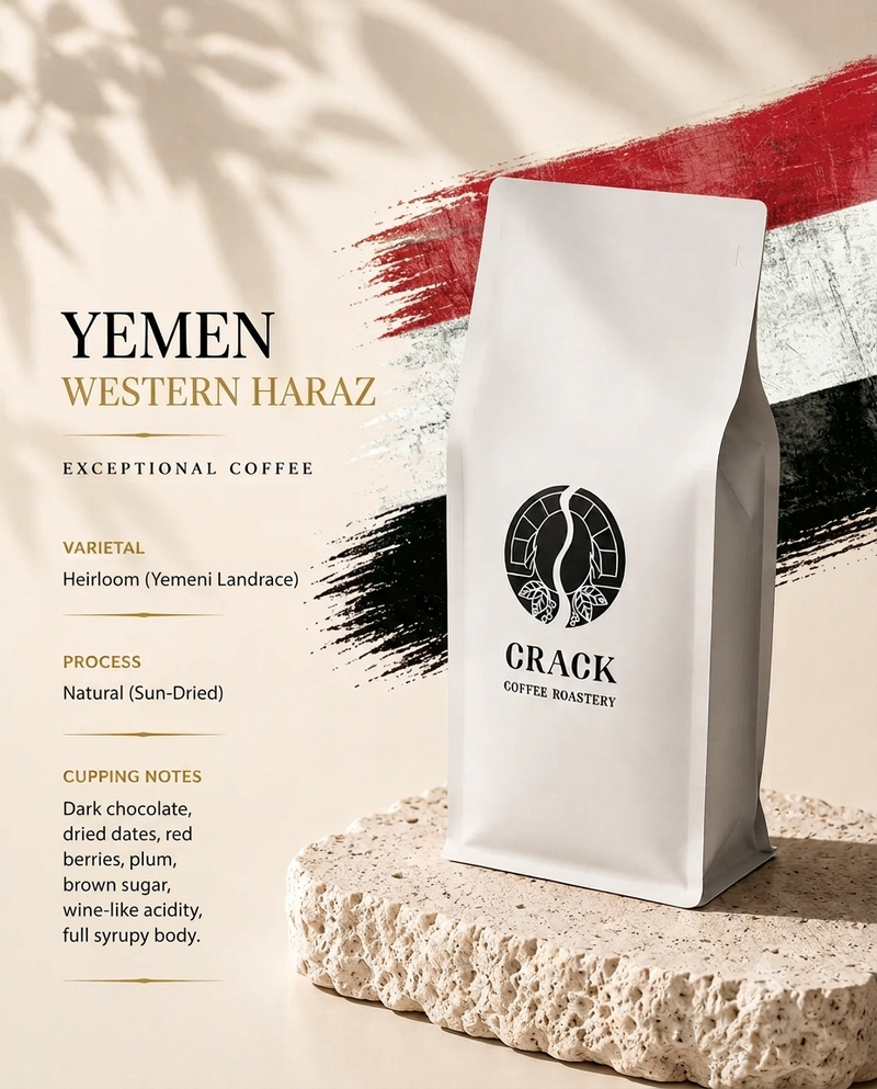 A white bag of Yemen Western Haraz coffee from Crack Coffee Roastery stands on a textured stone slab against a warm beige background with red, black, and white brushstroke graphics and product text.
