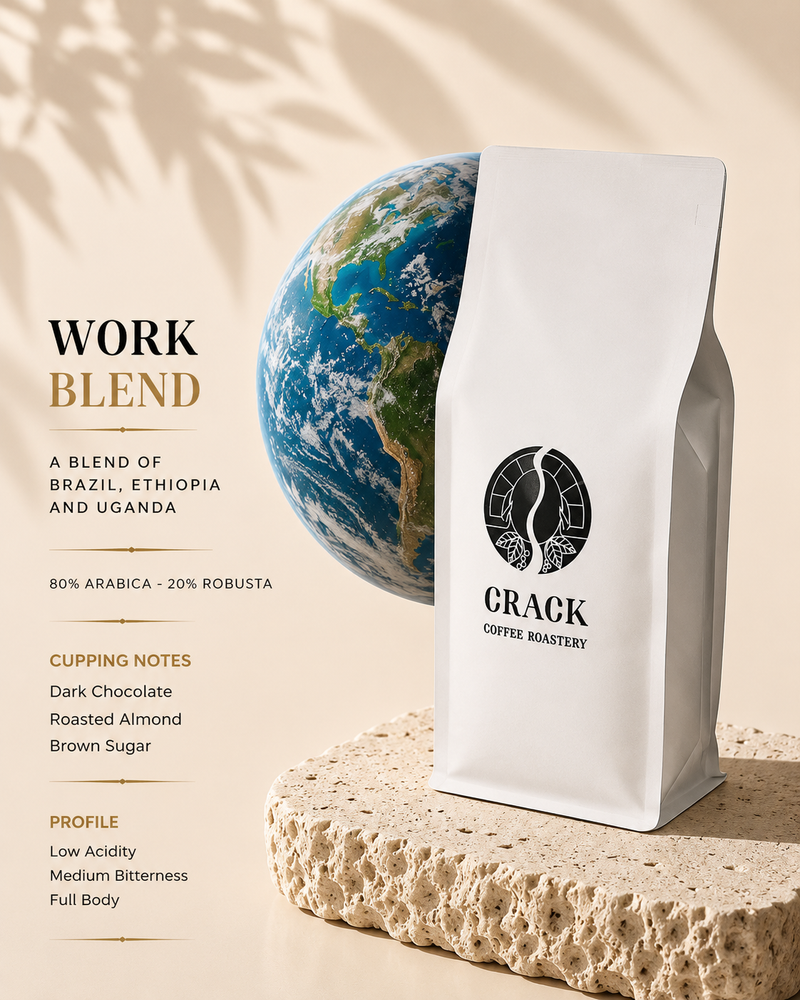 A white stand-up coffee bag labeled 'CRACK COFFEE ROASTERY' stands on a textured stone slab beside a globe graphic, with text on the left describing the work blend and cupping notes.